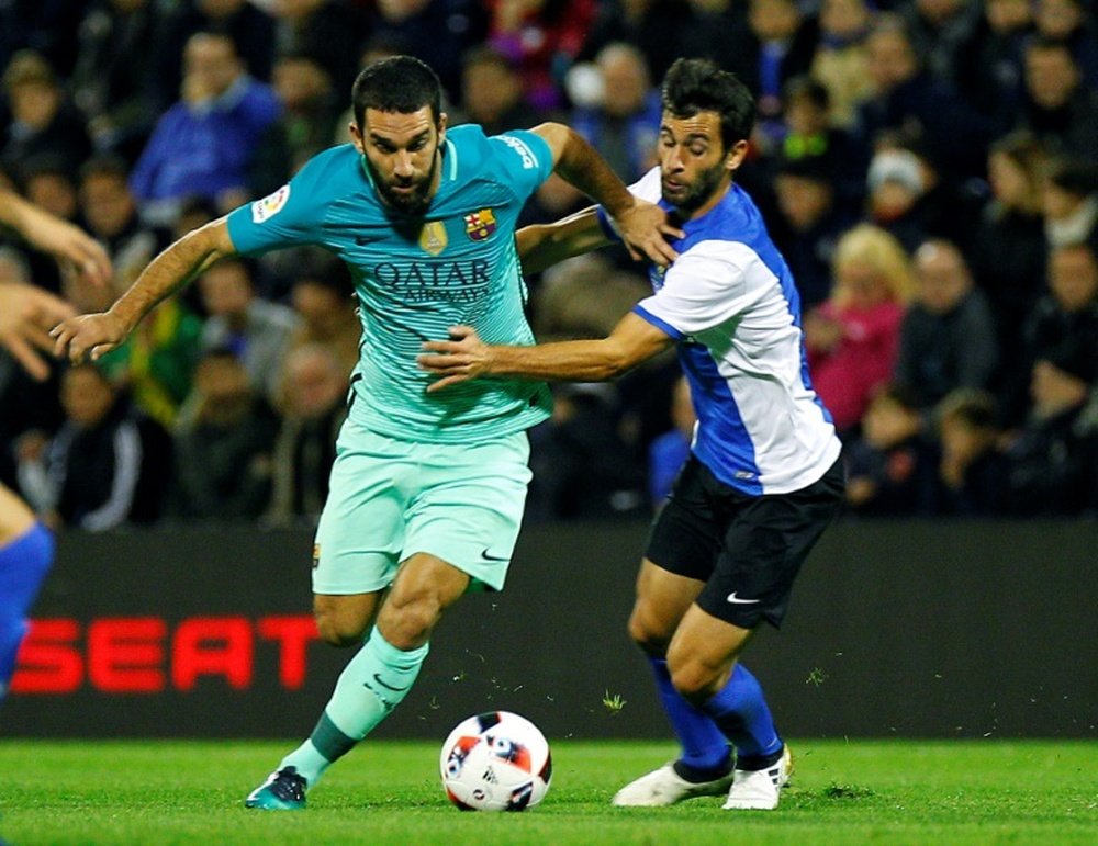 Arda Turan chasing the ball in a match. AFP