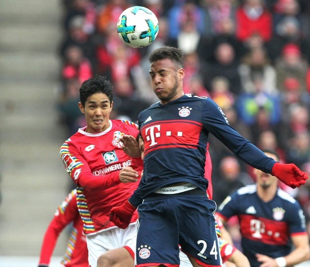 Muto battles Corentin Tolisso. AFP