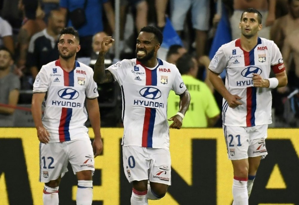 Lacazette celebrating a goal with his team-mates. AFP