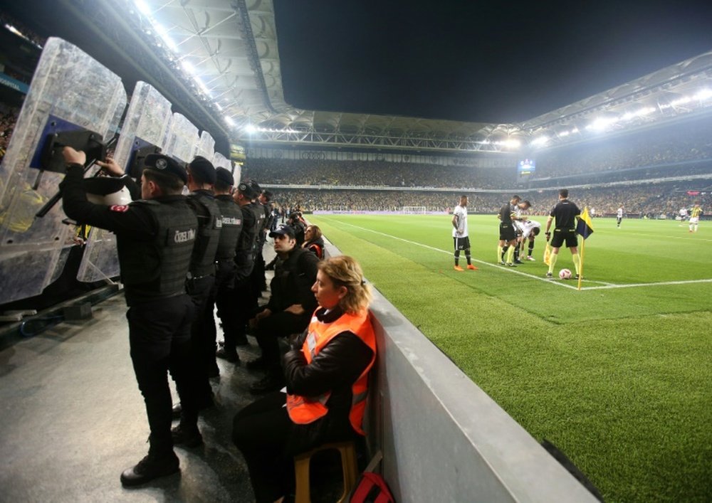 The match was abandoned after crowd trouble flared. AFP