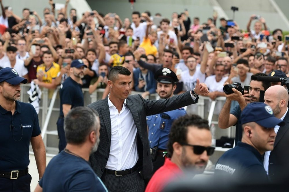 Fans flocked to the Juventus training ground to get a glimpse of the superstar. AFP