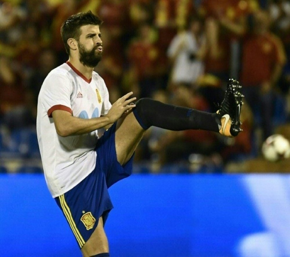 Pique warming up for the match against Albania. AFP