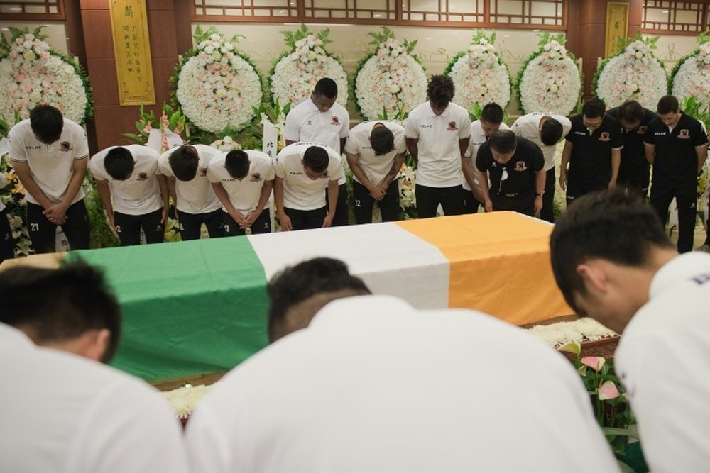 Mourners paid their respects to Cheick Tioté today at a memorial service in China. AFP