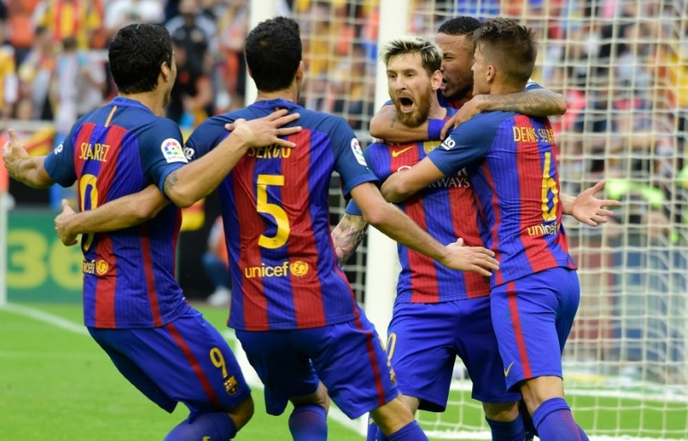 Messi is congratulated after scoring Barcelona's winning goal. AFP
