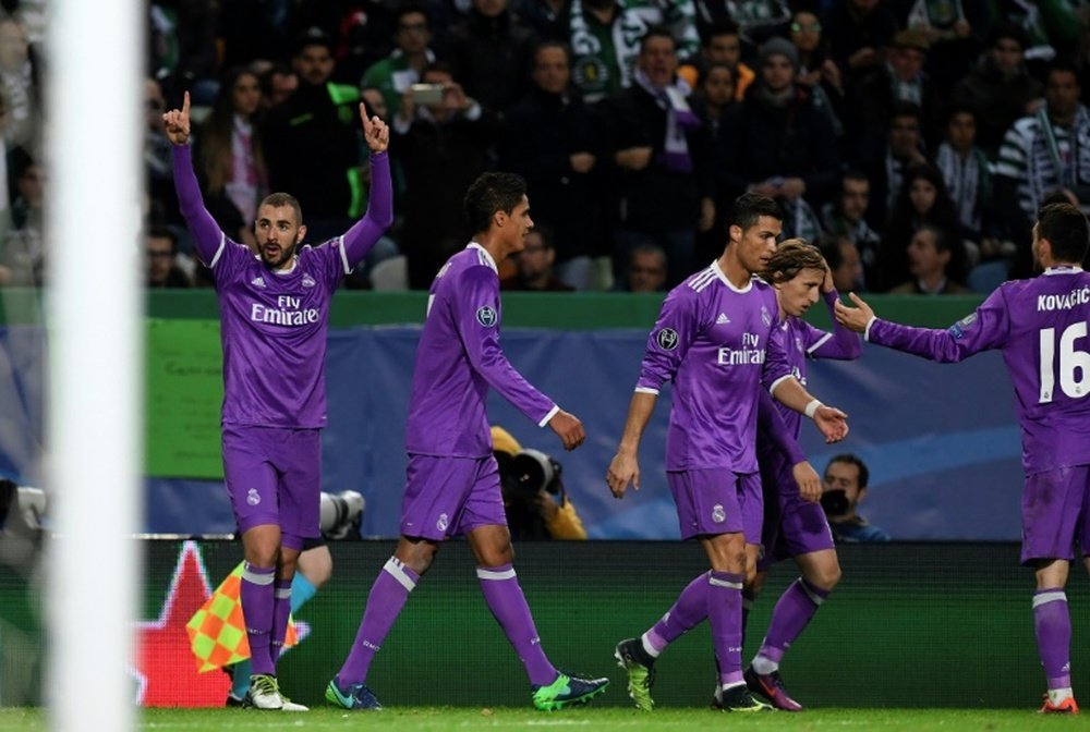 Real Madrid players celebrating a goal against Sporting. AFP