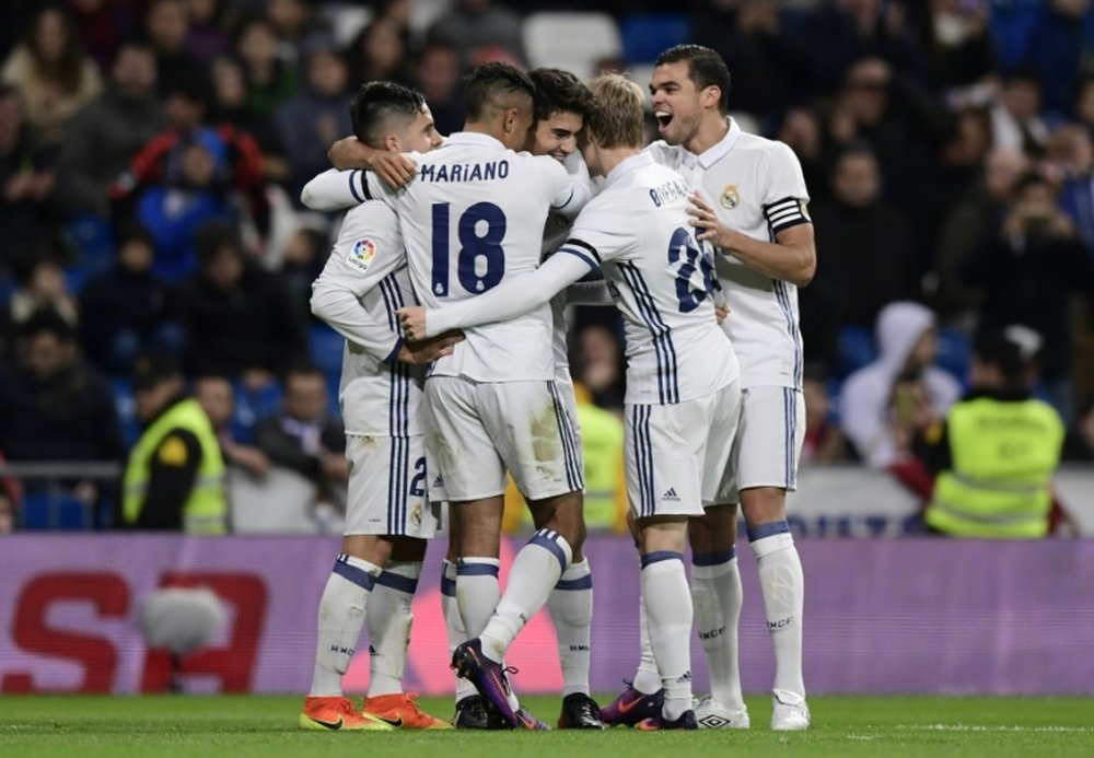 Real Madrid players celebrating a goal. AFP