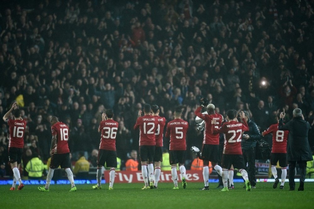 Les joueurs de Manchester United communient avec leurs fans lors du déplacement à Blackburn. AFP
