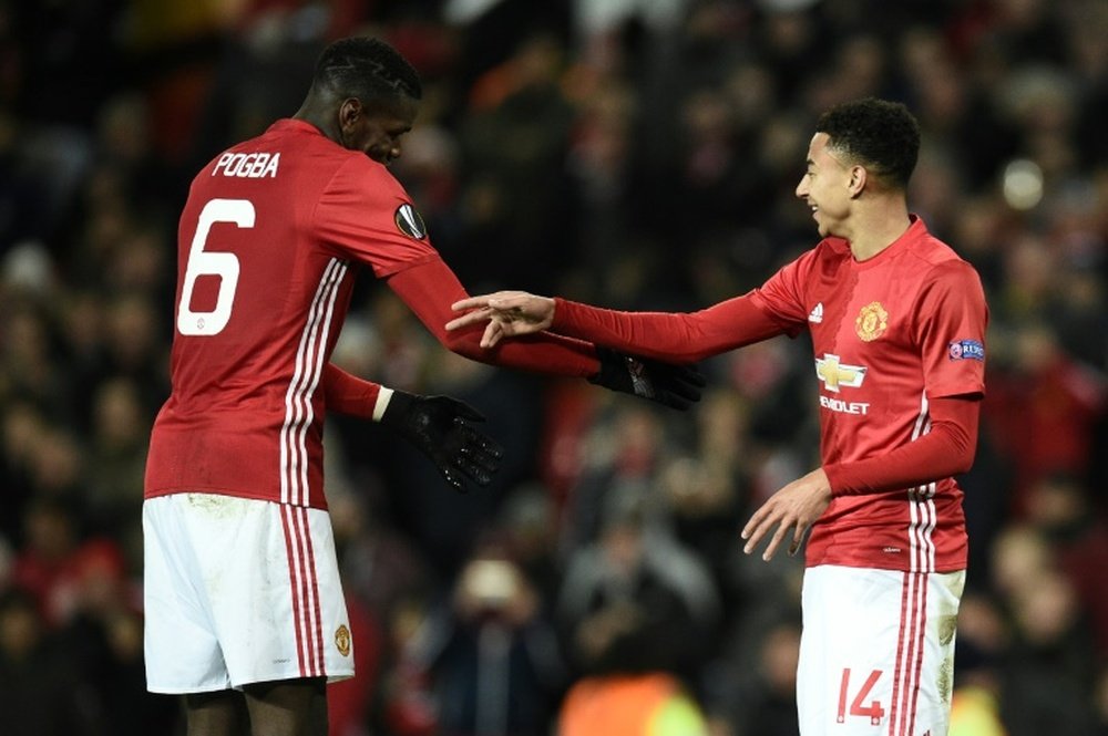 Paul Pogba and Jesse Lingard hugging. AFP