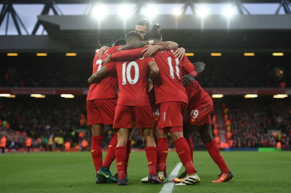Liverpool players celebrate a goal at Anfield. AFP
