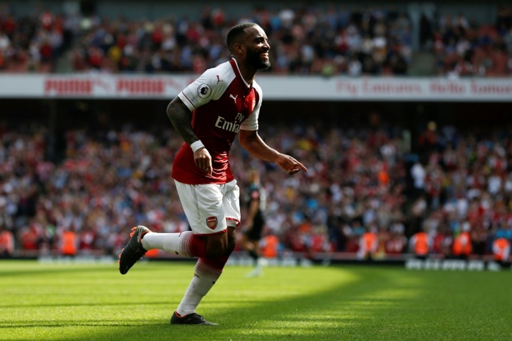 Lacazette wants Wenger to go out on a high. AFP