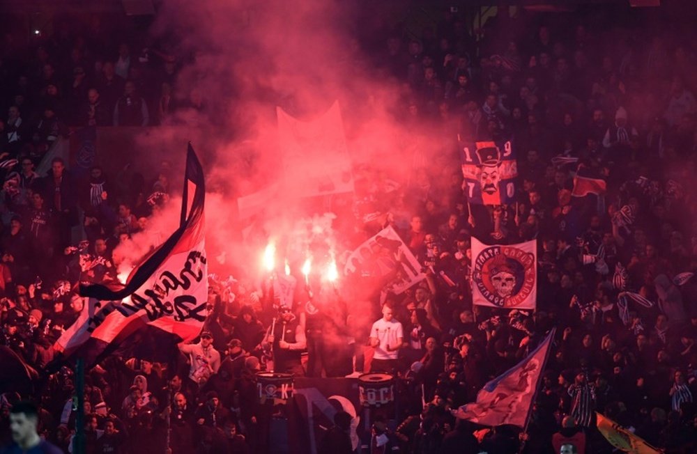 PSG supporters set off flairs during their side's clash with Real. AFP