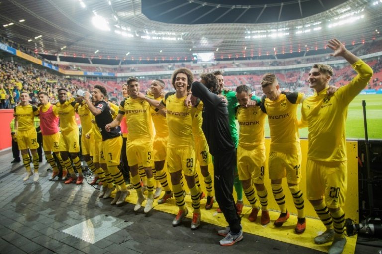 Dortmund players celebrate at full time in Leverkusen. AFP