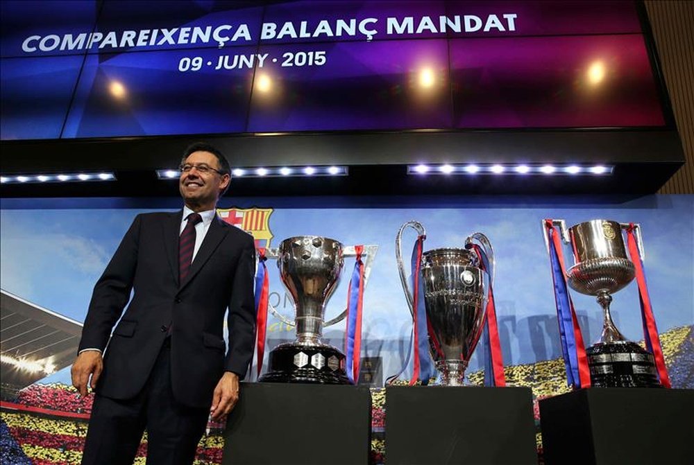 El presidente del FC Barcelona, Josep María Bartomeu, posa con los trofeos de la Liga, Liga de Campeones y Copa del Rey. EFE/Archivo