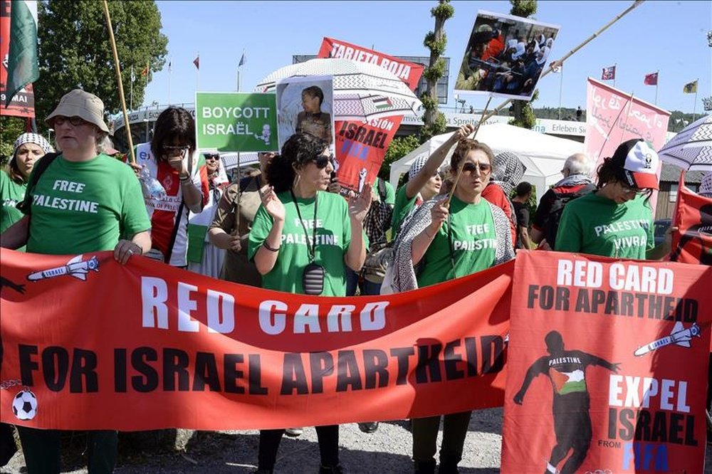Varias personas se manifiestan bajo el lema Cartulina roja para el Apartheid de Israel en las inmediaciones de la sede de la FIFA, el pasado mes de mayo. EFE/Archivo