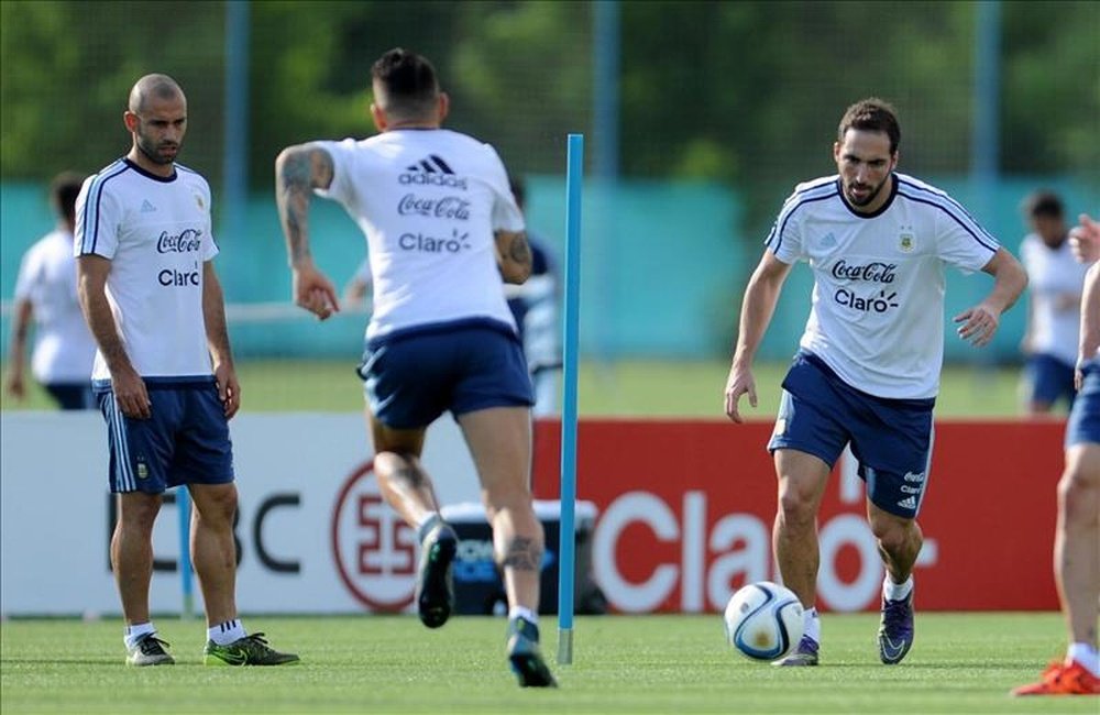 Los jugadores de la selección argentina de fútbol Javier Mascherano (i) y Gonzalo Higuain (d) fueron registrados este martes al participar en un entrenamiento, en la sede de la Asociación de Fútbol Argentino (AFA), en Ezeiza (provincia de Buenos Aires, Argentina). EFE