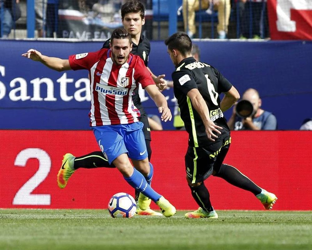 El centrocampista del Atlético de Madrid Koke Resurrección (i) pelea un balón con el centrocampista del Sporting de Gijón Sergio Álvarez en partido de la cuarta jornada de liga en Primera División que se disputó en el estadio Vicente Calderón. EFE