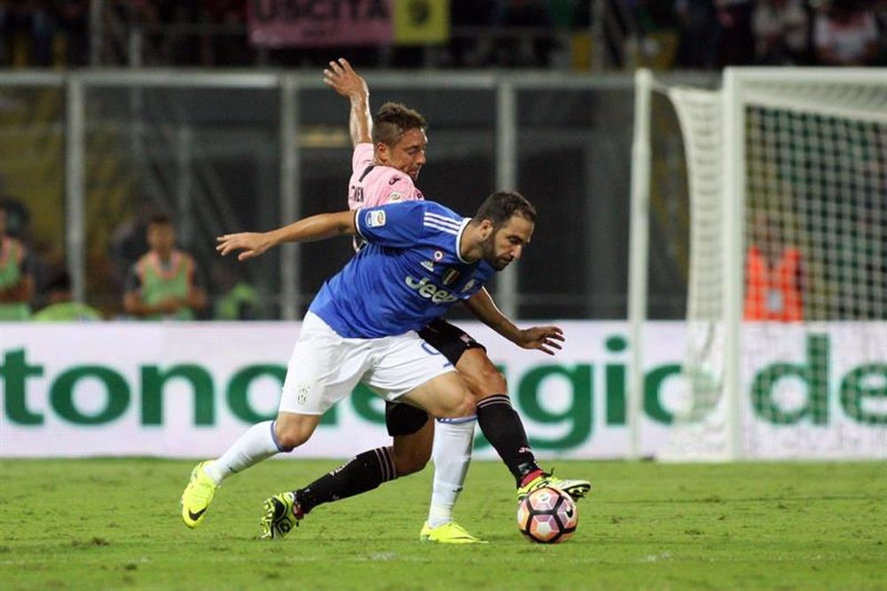 El defensa polaco del Palermo Thiago Cionek y el delantero argentino del Juventus Gonzalo Higuain persiguen un balón en el Renzo Barbera dePalermo, Italia. EFE/EPA