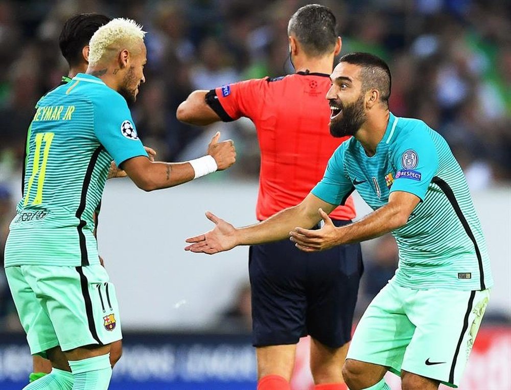 Neymar and Arda Turan celebrating a goal. AFP