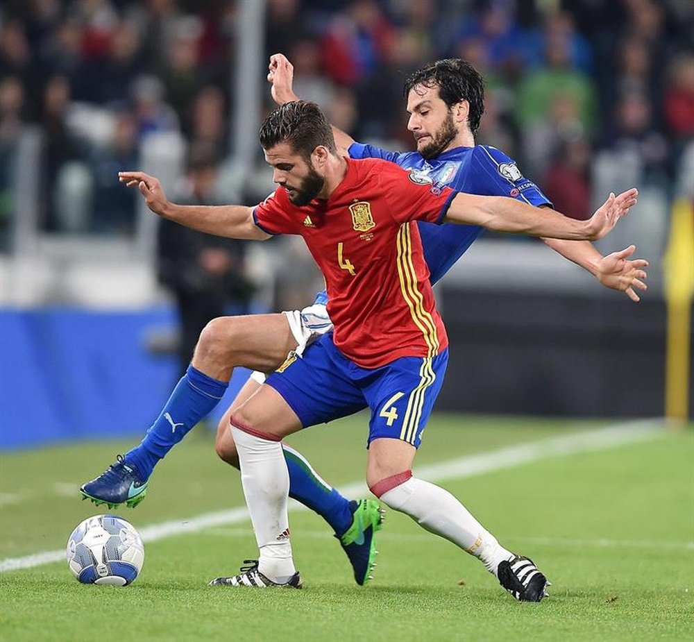 Spain's Nacho battling for the ball. EFE