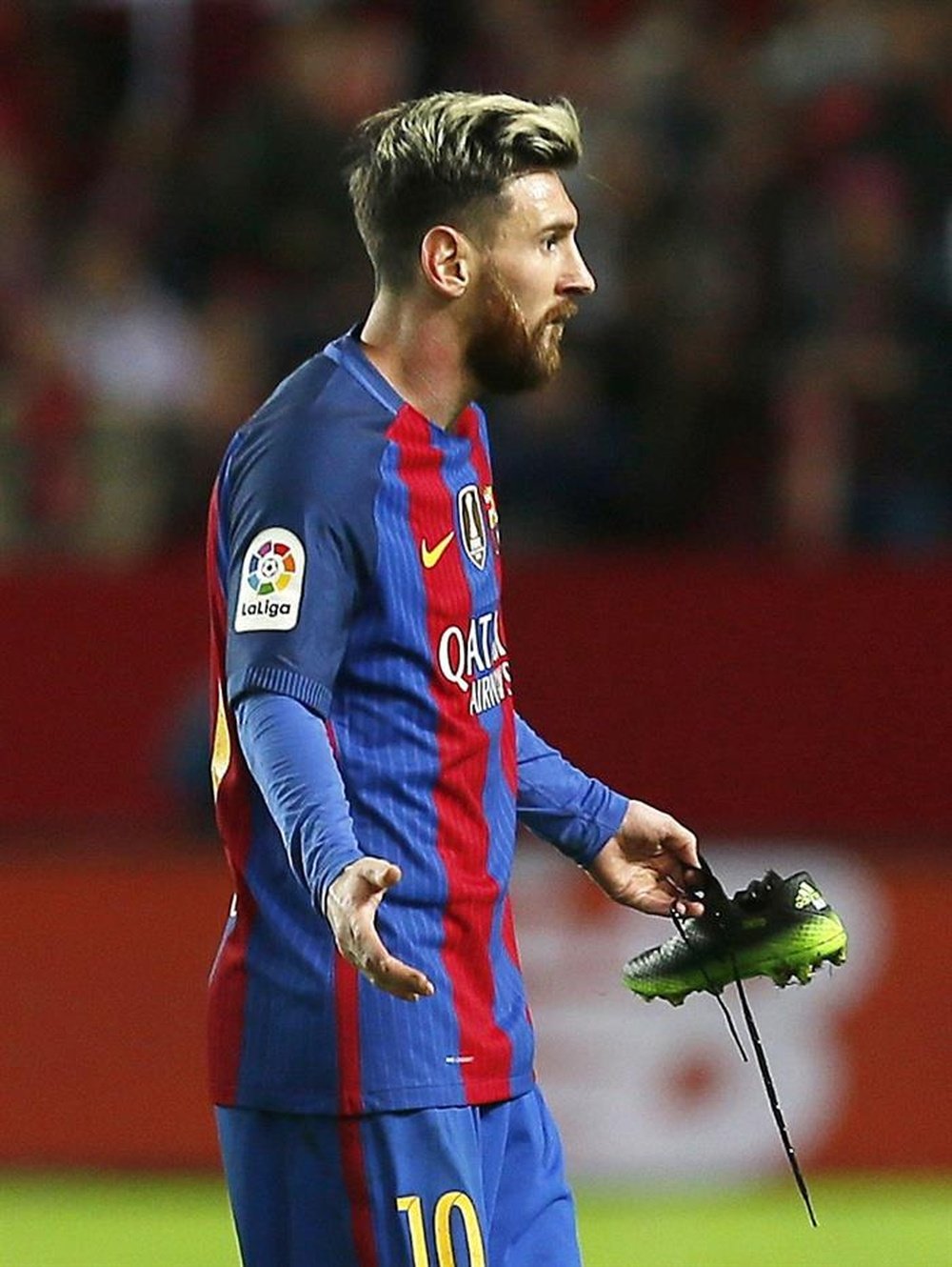 Messi complains as he gets booked for time wasting despite having broken laces. AFP