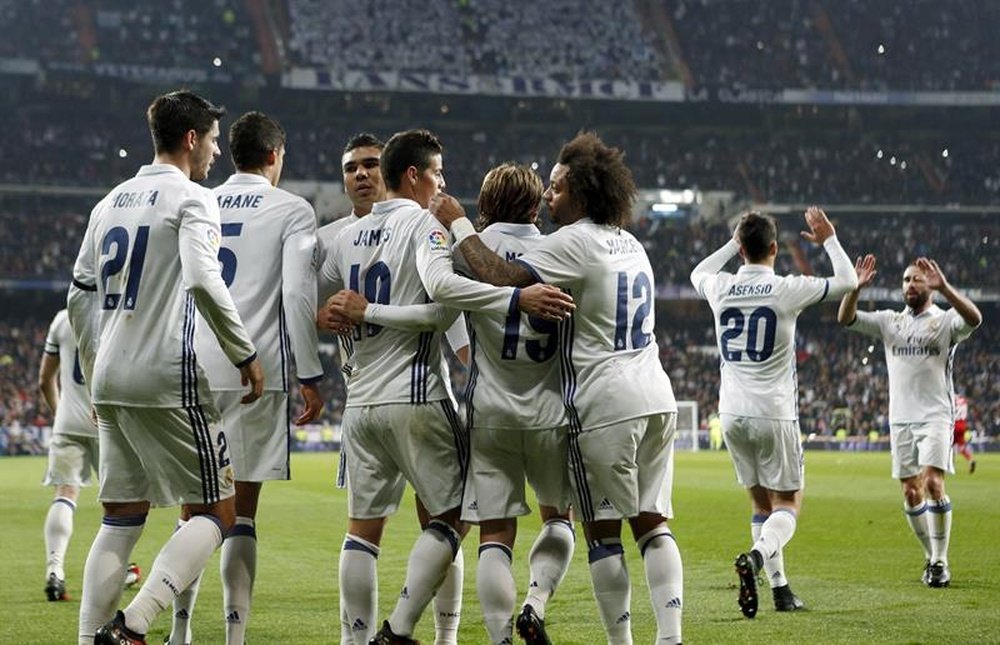 Real Madrid players celebrating a goal. AFP
