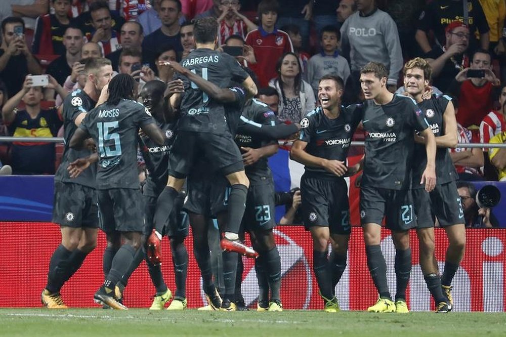 The Chelsea players celebrate their last-gasp winner. AFP