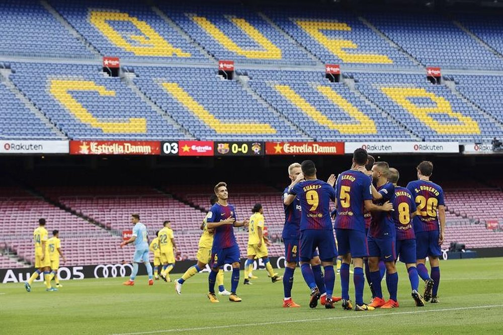 The Barca players celebrat Busquets' opener in front of an empty Camp Nou. AFP