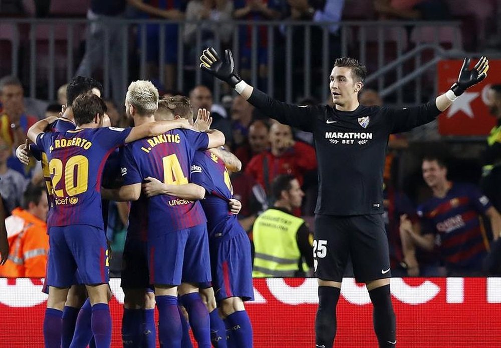 Barcelona celebrate their first goal while Prieto stands bemused. EFE