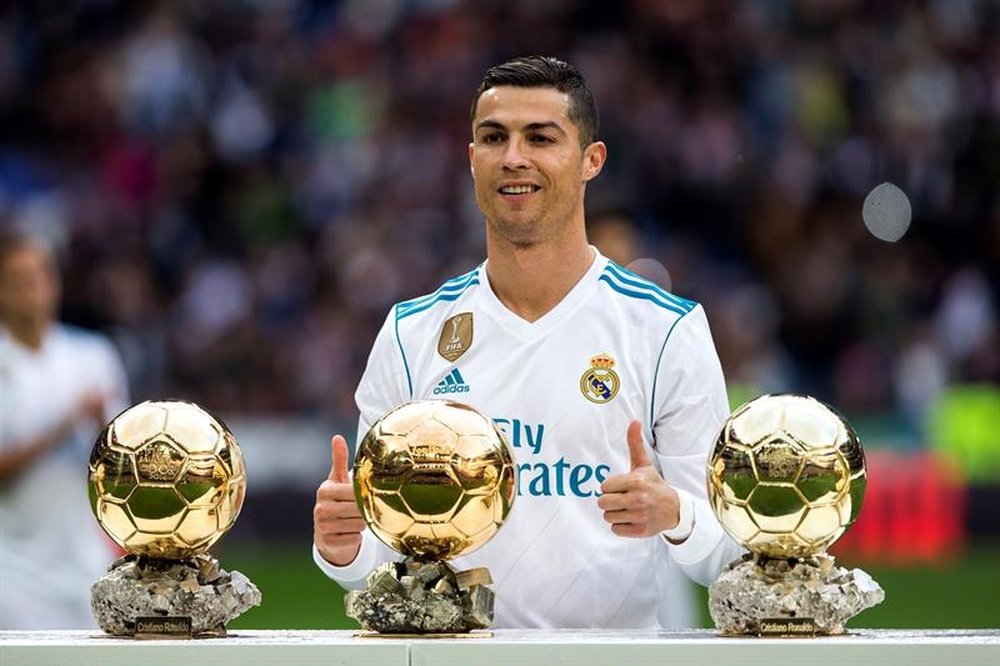 Cristiano Ronaldo poses with his five Ballon dOr trophies. AFP