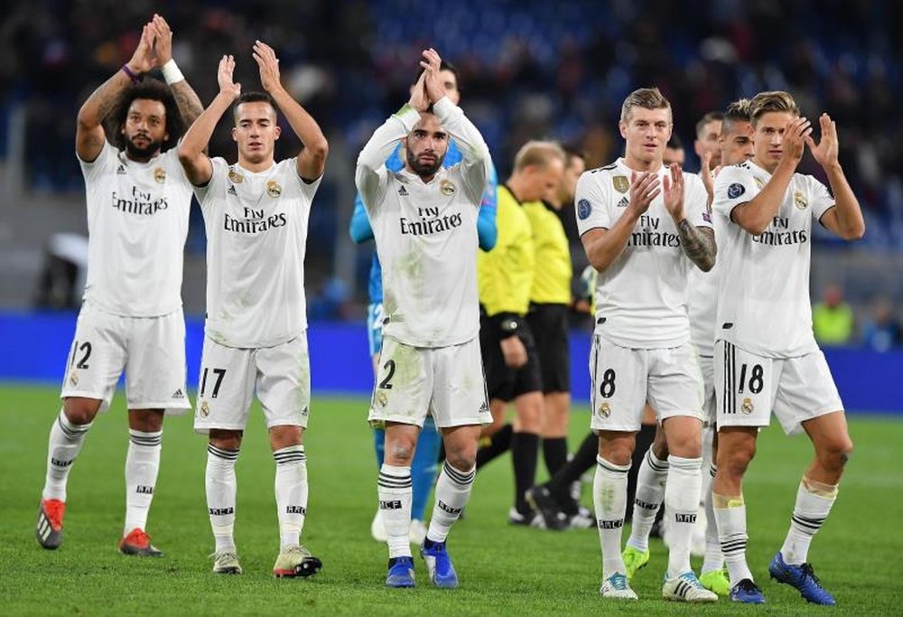 Real Madrid players celebrate their progression to the Champions League knockout stage. EFE