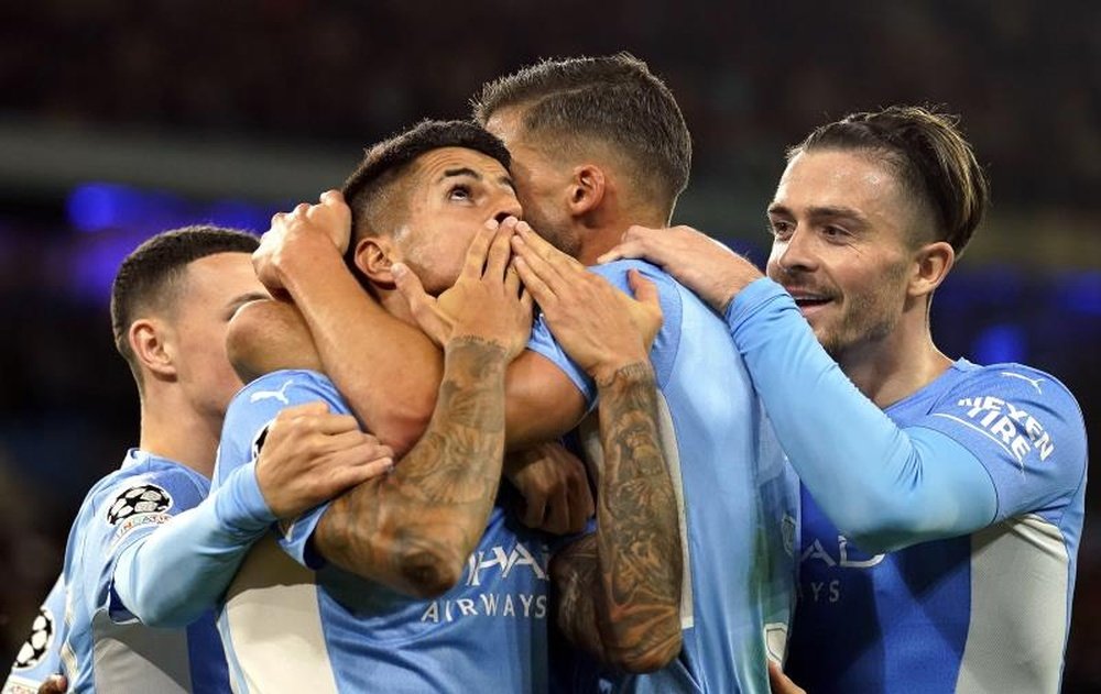 Manchester City's Joao Cancelo (C) celebrates with teammates after scoring. AFP