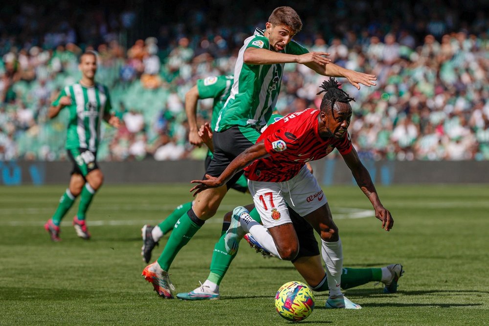 Edgar González defensa del Real Betis, y el delantero zimbabuense del MallorcaTino Kadewere (d), del Mallorca, disputan un balón durante el partido de la jornada 26 de LaLiga que estos dos equipos jugaron en el estadio Benito Villamarín. EFE/Julio Muñoz