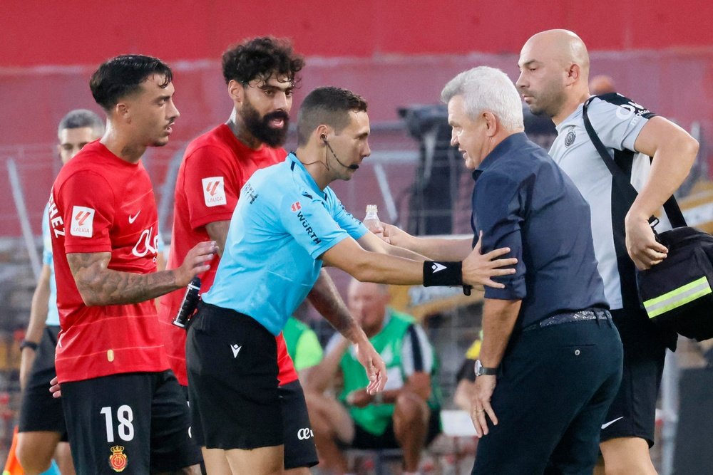 El técnico mexicano del Mallorca, Javier Aguirre (d), conversa con el colegiado Hernández Maeso, durante el encuentro correspondiente a la jornada nueve de primera división que disputan Mallorca y Valencia en el estadio de Son Moix, en Mallorca. EFE/CATI CLADERA.