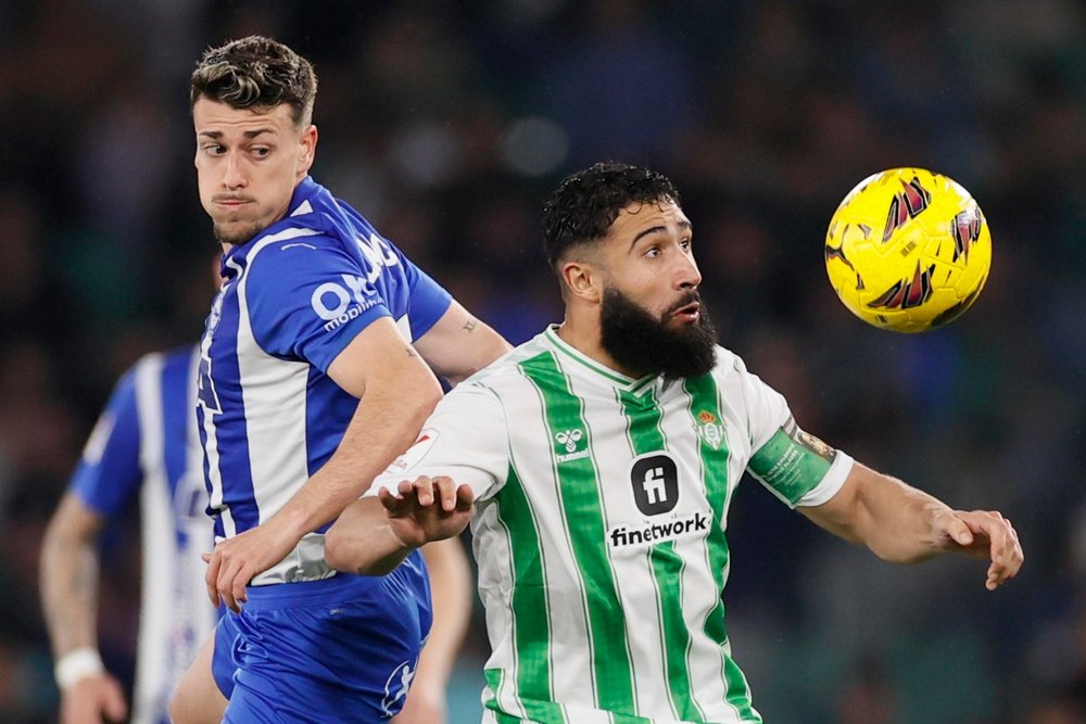 El centrocampista francés del Betis Nabil Fekir (d) lucha con Antonio Blanco, del Alavés, durante el partido de la jornada 25 de LaLiga EA Sports disputado en el estadio Benito Villamarín de Sevilla. EFE/José Manuel Vidal