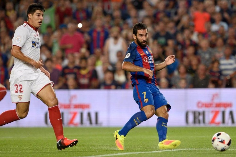 Arda Turan shoots to score Barcelona's first goal of the evening. AFP