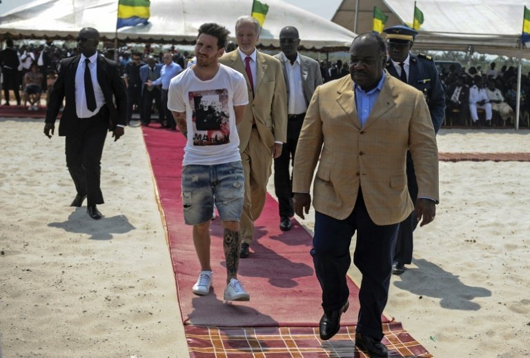 Argentinian soccer player Lionel Messi (C) is given a tour during the start of construction of the Port-Gentil Stadium by the President of Gabon, Ali Bongo Ondimba (R) on July 18, 2015.