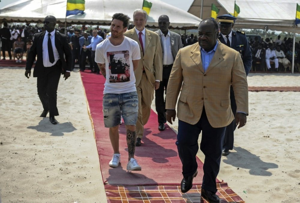 Argentinian soccer player Lionel Messi (C) is given a tour during the start of construction of the Port-Gentil Stadium by the President of Gabon, Ali Bongo Ondimba (R) on July 18, 2015.