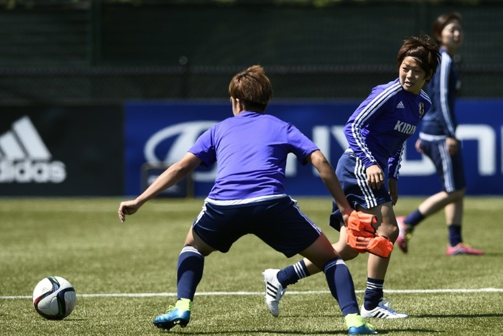 Aya Miyama (R) eyes the ball during a training session in Vancouver, British Columbia, on July 4, 2015, on the eve of their FIFA WWC final against the US