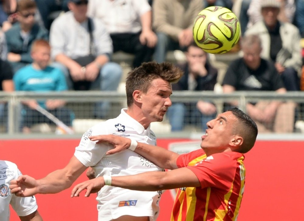 Benjamin Stambouli (left), playing for Montpellier, outjumps Lens Alharbi El Jadeyaoui in a Ligue 1 match in Amiens on May 10, 2015