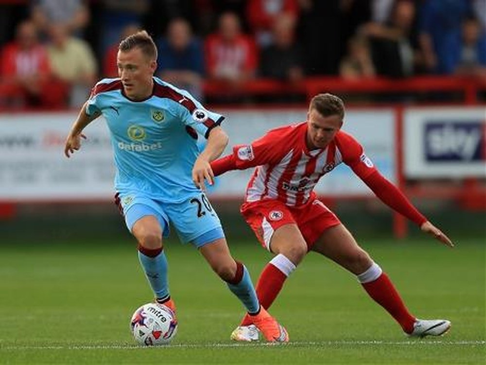 Burnley's Ulvestad is closely watched by Accrington Stanley's Hewitt. BurnleyFootballClub