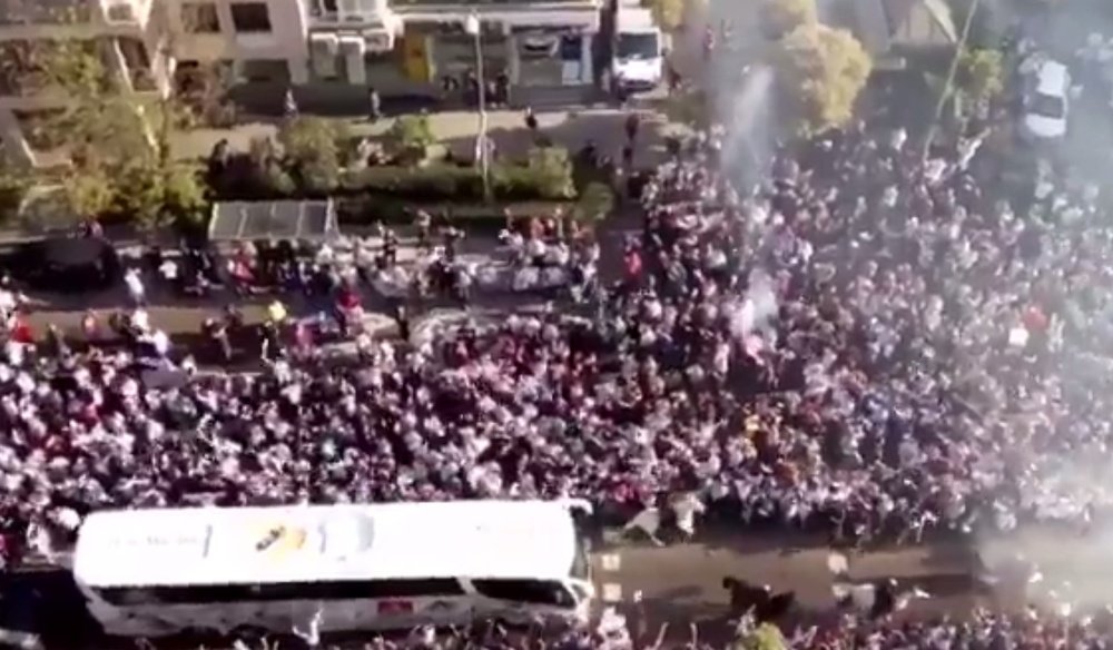 Real Madrid's team bus surrounded by chanting fans. Twitter