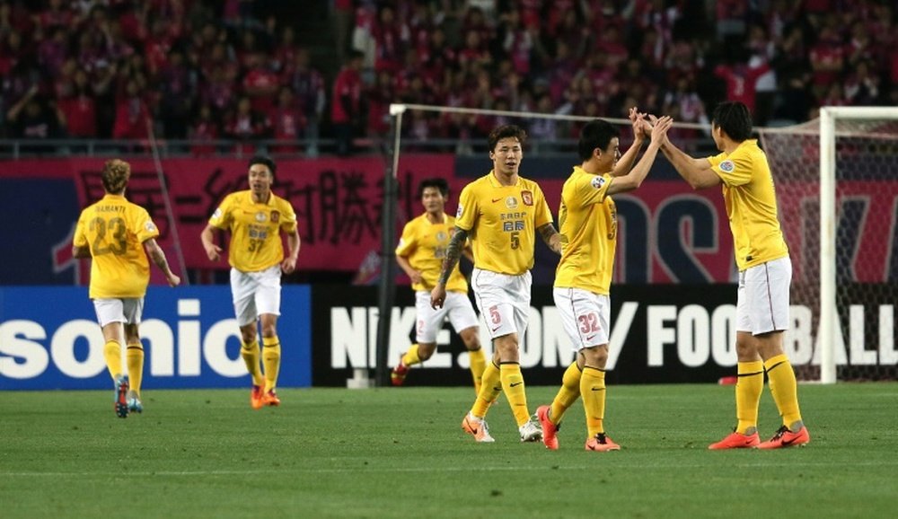 China Guangzhou Evergrande players celebrate after scoring a goal during an AFC Champions League match in Osaka, in May 2014