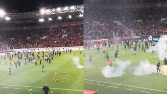 El partido entre el Olympiacos y el AEK de Atenas acabó con la invasión de campo de los aficionados locales, que lanzaron bombas de humo y destrozaron asientos mientras los jugadores visitantes huían a vestuarios.