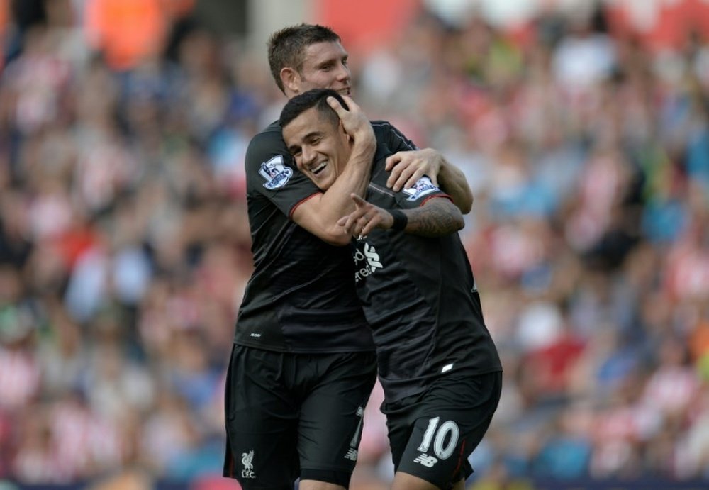 Coutinho with Milner celebrating a goal this season with Liverpool. AFP