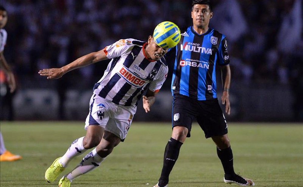 El jugador de Querétaro, Pato Rubio, disputa el esférico en un partido ante Monterrey. EFE