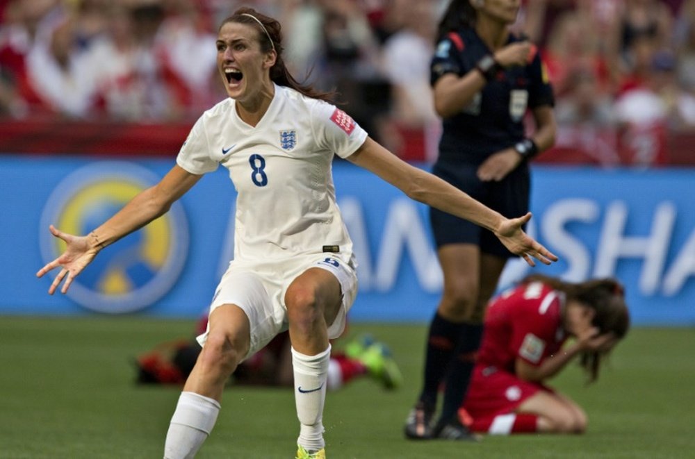 England midfielder Jill Scott celebrates as Canada defender Allysha Chapman (R) reacts to their loss during a quarterfinal football match at the 2015 Women World Cup in Vancouver on June 27, 2015