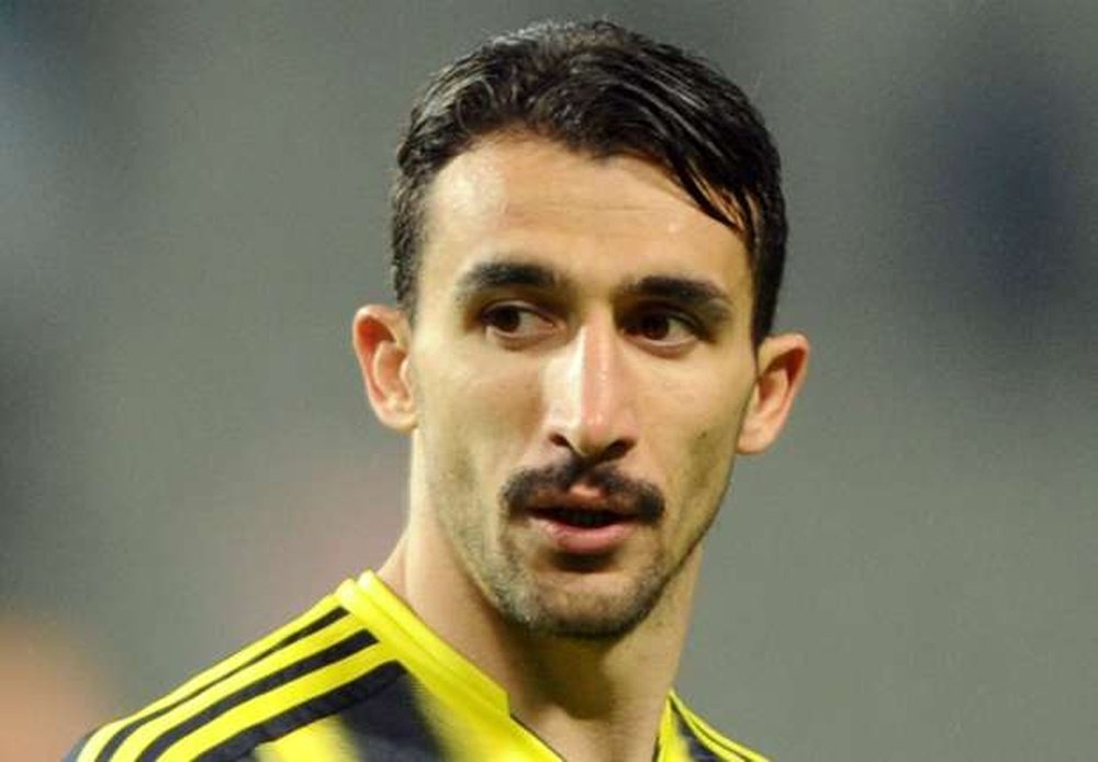 Fenerbahce's Mehmet Topal luckily escapes unharmed