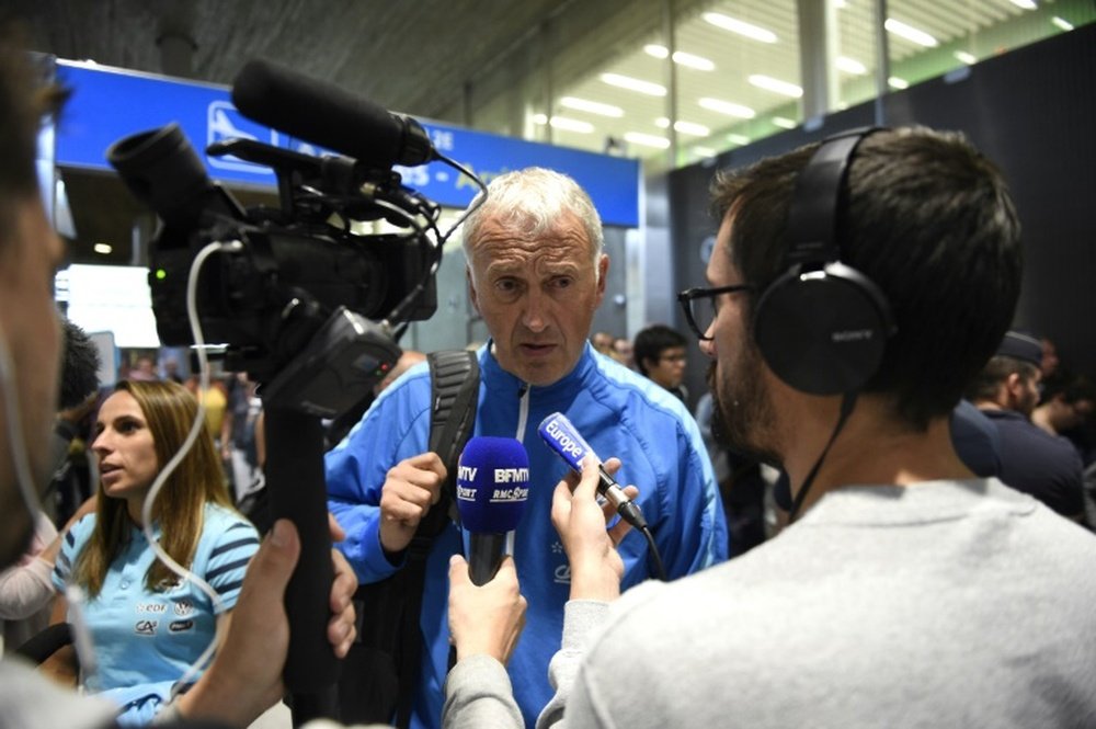 French Women national football team head coach, Philippe Bergeroo answers journalists as he arrives with the team at Paris Roissy Charles De Gaulle airport on June 29, 2015, in Roissy-en-France