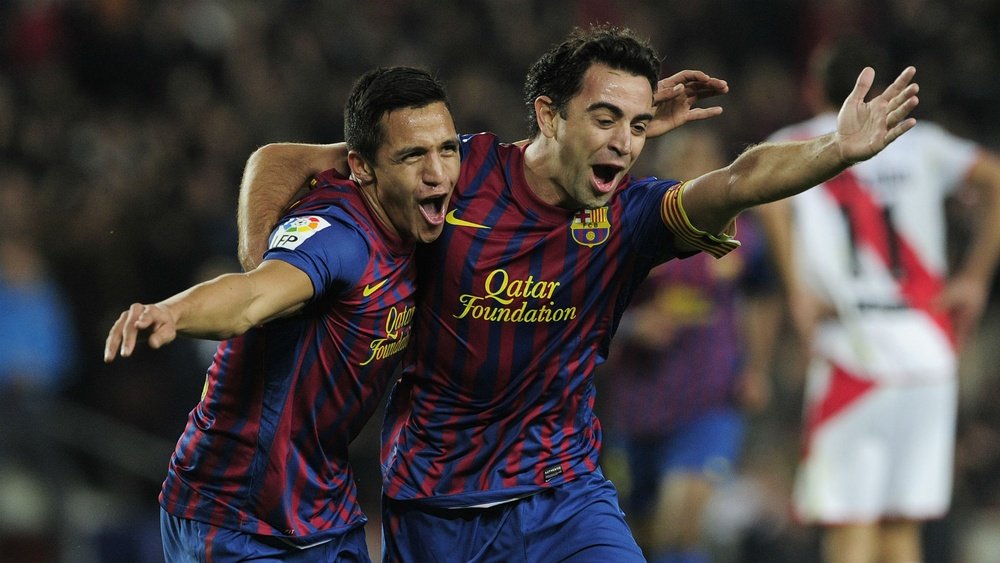 Alexis Sanchez (L) celebrates with Xavi (R) while at Barcelona. Goal