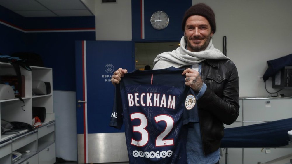 Beckham posing with a signed shirt. Goal